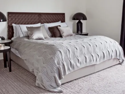 Letto con testiera realizzata con pannelli in cuoio intrecciato Cestone di Flexform